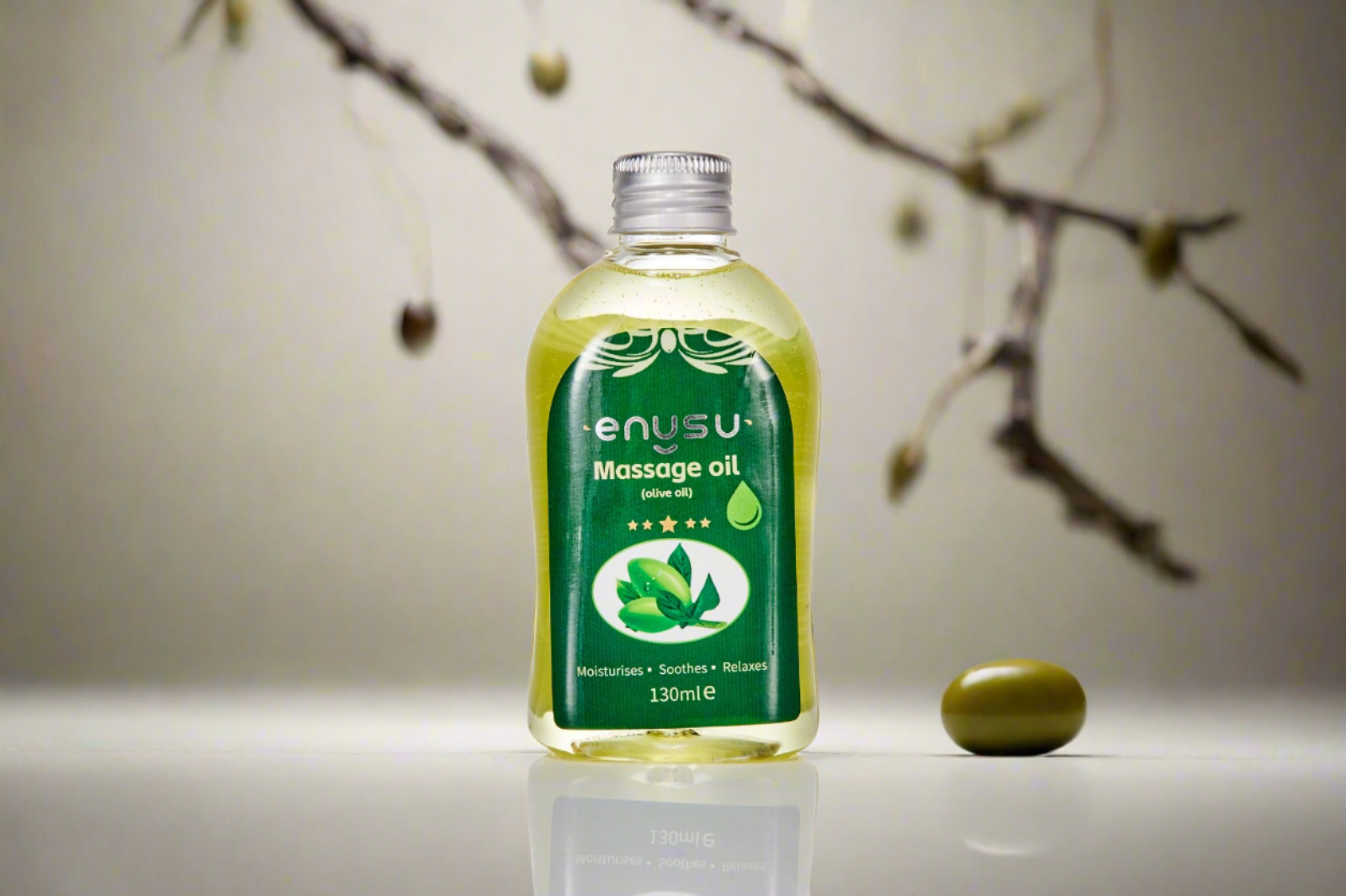 Enusu LADYBLOOM massage oil bottle with a green label on a neutral background